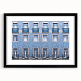 Colorful abstract art print of Lisbon scenery in vibrant hues on a large textured canvas, framed in black.