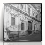 Large abstract wall art depicting a stylized Barcelona cityscape in muted earth tones, framed in black acrylic.