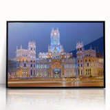 Large abstract wall art of Madrid's cityscape in muted gray and blue tones on a black framed acrylic.