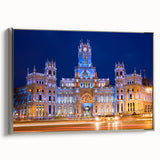 Vintage poster art of Madrid with colorful imagery in a silver-framed canvas, ideal for living room decor.
