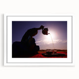 Abstract art print of Middle Eastern scenery in muted earth tones on a white framed mat, suitable for dining room decor.