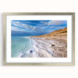 Textured abstract art print of the Dead Sea in muted blues and grays, framed in silver, ideal for bedroom art.