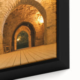 Close-up of a textured, extra large framed canvas depicting a Middle Eastern scenery in black with colorful accents.