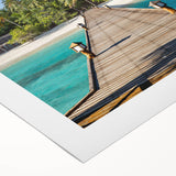 Art deco poster of a serene Tahitian landscape with ocean and palm trees in muted blues and greens, on rolled canvas.