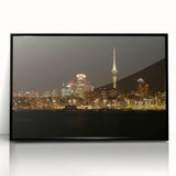 Large abstract wall art of Auckland's skyline in muted gray and blue tones on a black framed acrylic.