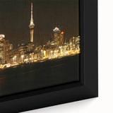 Black framed canvas featuring a textured, colorful depiction of Auckland's skyline, ideal for living room decor.