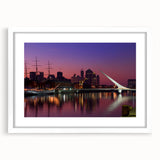 Abstract art print of Buenos Aires skyline in muted blue and gray tones on a white framed canvas.