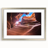 Textured art print of Arizona's Antelope Canyon in muted earth tones, framed in silver, ideal for bedroom decor.