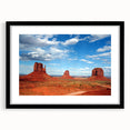 Extra large abstract art print of Monument Valley in vibrant colors on a textured canvas, framed in black.