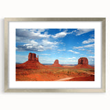 Textured art print of Monument Valley in muted earth tones on a framed matte canvas, suitable for bedroom decor.