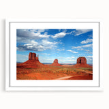 Abstract art print of Monument Valley in muted earth tones on a framed white mat, suitable for dining room decor.