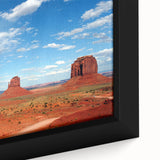 Extra large framed canvas of Monument Valley in black with colorful, textured art, suitable for living room decor.