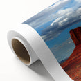 Art deco poster of Monument Valley in Arizona on rolled canvas, featuring earthy red and orange tones.