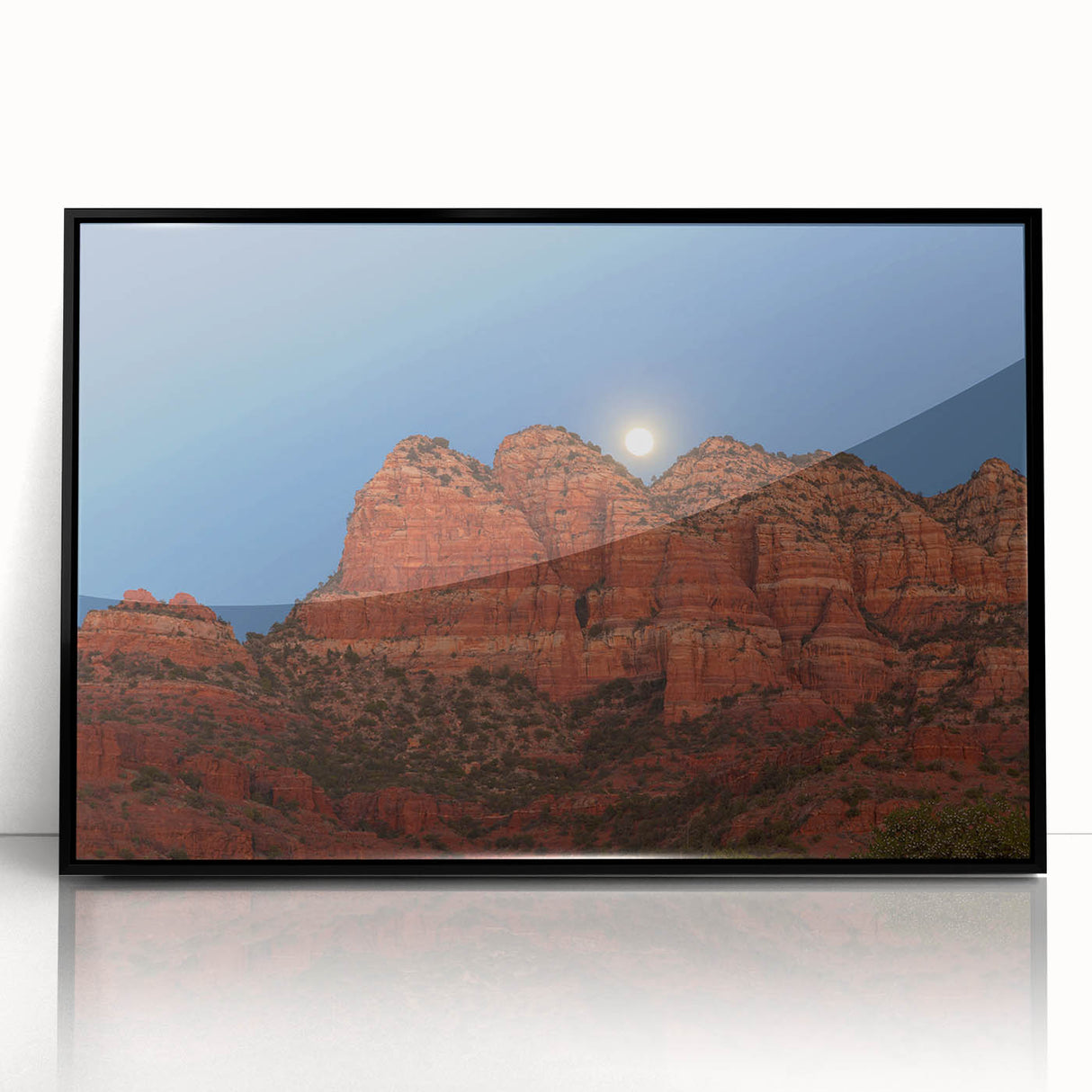 Large abstract wall art depicting the Sedona landscape in vibrant red and orange tones, framed in black acrylic.