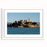 Abstract art print of Alcatraz Island in muted blue and gray tones, framed with a white mat, suitable for dining room decor.