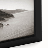 Close-up of textured black wall art depicting the Big Sur coastline in vibrant colors on a framed canvas.