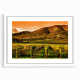 Abstract art print of Napa Valley with muted earth tones on a white framed mat, ideal for dining room decor.