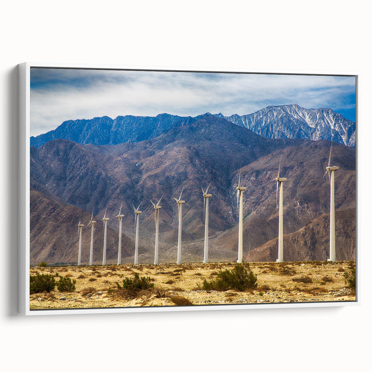 Vintage poster art of Palm Springs with colorful palm trees on a white framed canvas.