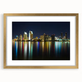 Extra large abstract art print of San Diego skyline in muted blue and gold tones, framed in gold.