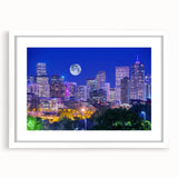 Abstract art print of Denver skyline in muted blue and orange tones on a framed canvas, suitable for dining room decor.
