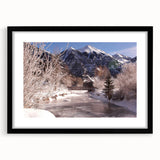 Abstract art print depicting textured Colorado scenery in vibrant colors, framed in black, ideal for large living room walls.
