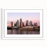 Abstract art print of Tampa skyline in muted blues and grays on a framed white mat, ideal for dining room decor.
