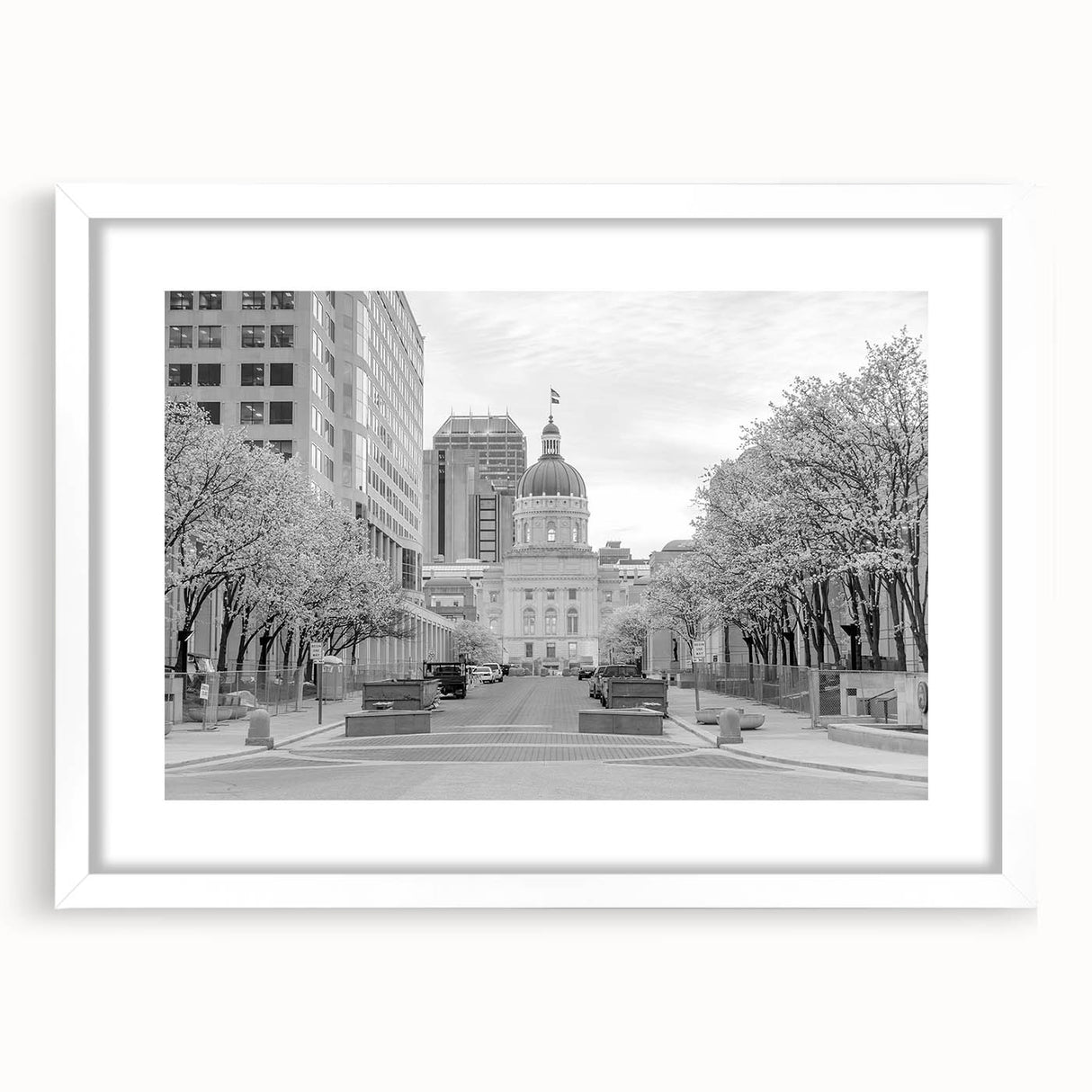 Abstract art print of Indianapolis skyline in muted gray and blue tones on a framed white mat, ideal for dining room decor.