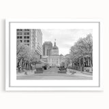 Abstract art print of Indianapolis skyline in muted gray and blue tones on a framed white mat, ideal for dining room decor.