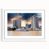 Abstract art print of New Orleans scenery in muted green and blue tones on a white framed canvas.