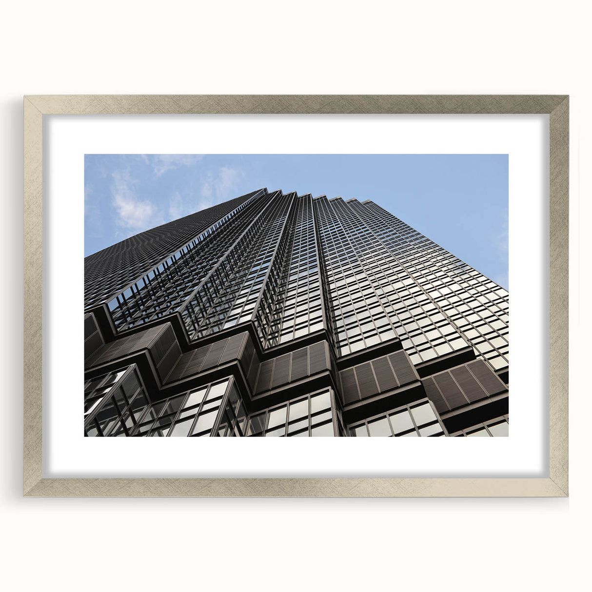 Textured abstract art print of Minneapolis skyline in muted gray and blue tones, framed with a silver mat.