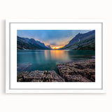 Abstract art print of Glacier National Park in muted blue and green tones on a framed white mat, ideal for dining room decor.