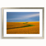 Textured art depicting abstract Nebraska scenery in muted earth tones on a framed silver mat, suitable for bedroom decor.