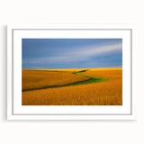 Abstract art print of Nebraska scenery in muted earth tones on a framed white mat, suitable for bedroom or dining room decor.