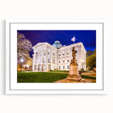 Abstract art print of Raleigh skyline in muted blue and gray, framed with a white mat, ideal for dining room decor.