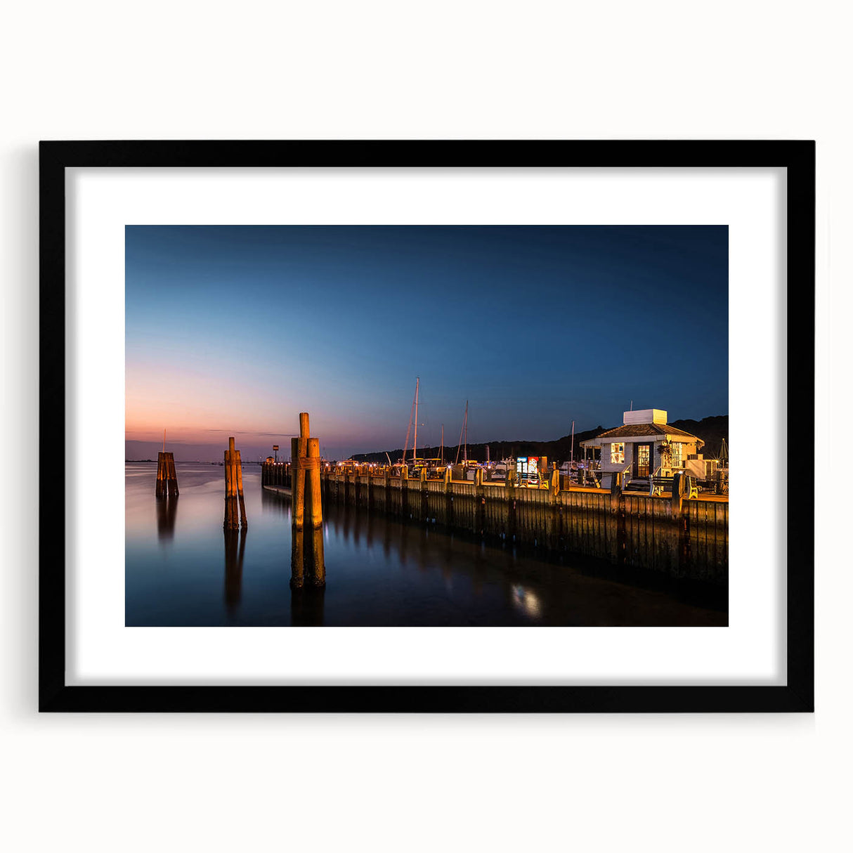 Abstract art print of a colorful, textured scenery, in a large black frame, suitable for living room decor.