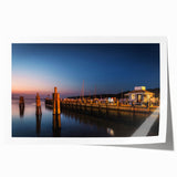 Rolled canvas print of Long Island scenery with muted blue and green floral accents.