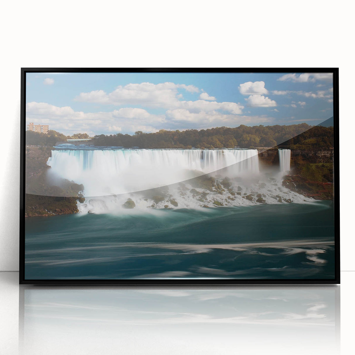 Large abstract wall art of Niagara Falls in muted blue and gray tones, framed in black acrylic.