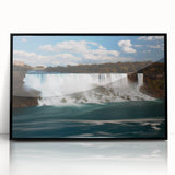 Large abstract wall art of Niagara Falls in muted blue and gray tones, framed in black acrylic.