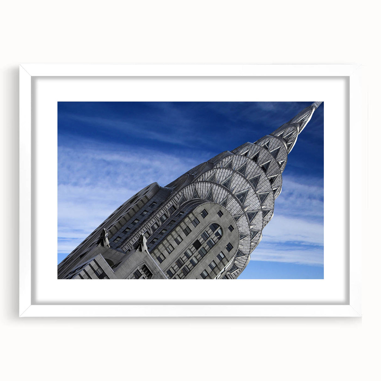 Abstract art print of the NYC Chrysler Building in muted gray tones, framed with a white mat, suitable for dining room decor.