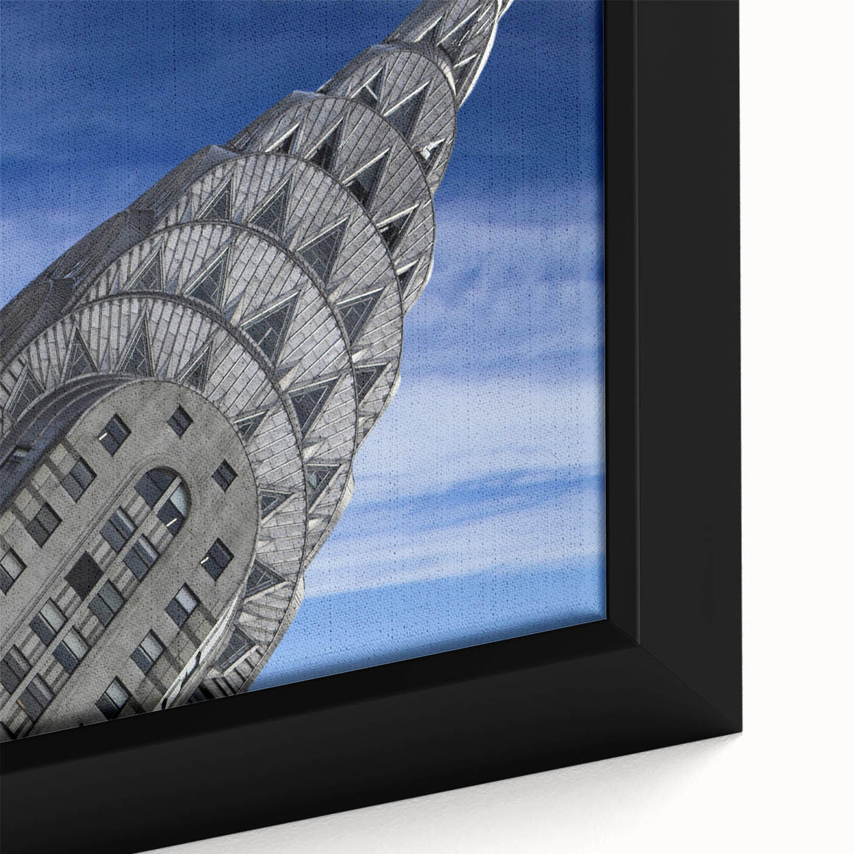 Close-up of black wall art featuring a textured depiction of the Chrysler Building in colorful hues on a framed canvas.