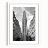 Abstract art print of NYC Rockefeller scenery in muted blue and gray, framed with a white mat.