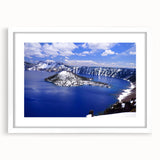 Abstract art print of Crater Lake in muted blue and green tones, framed with a white mat.