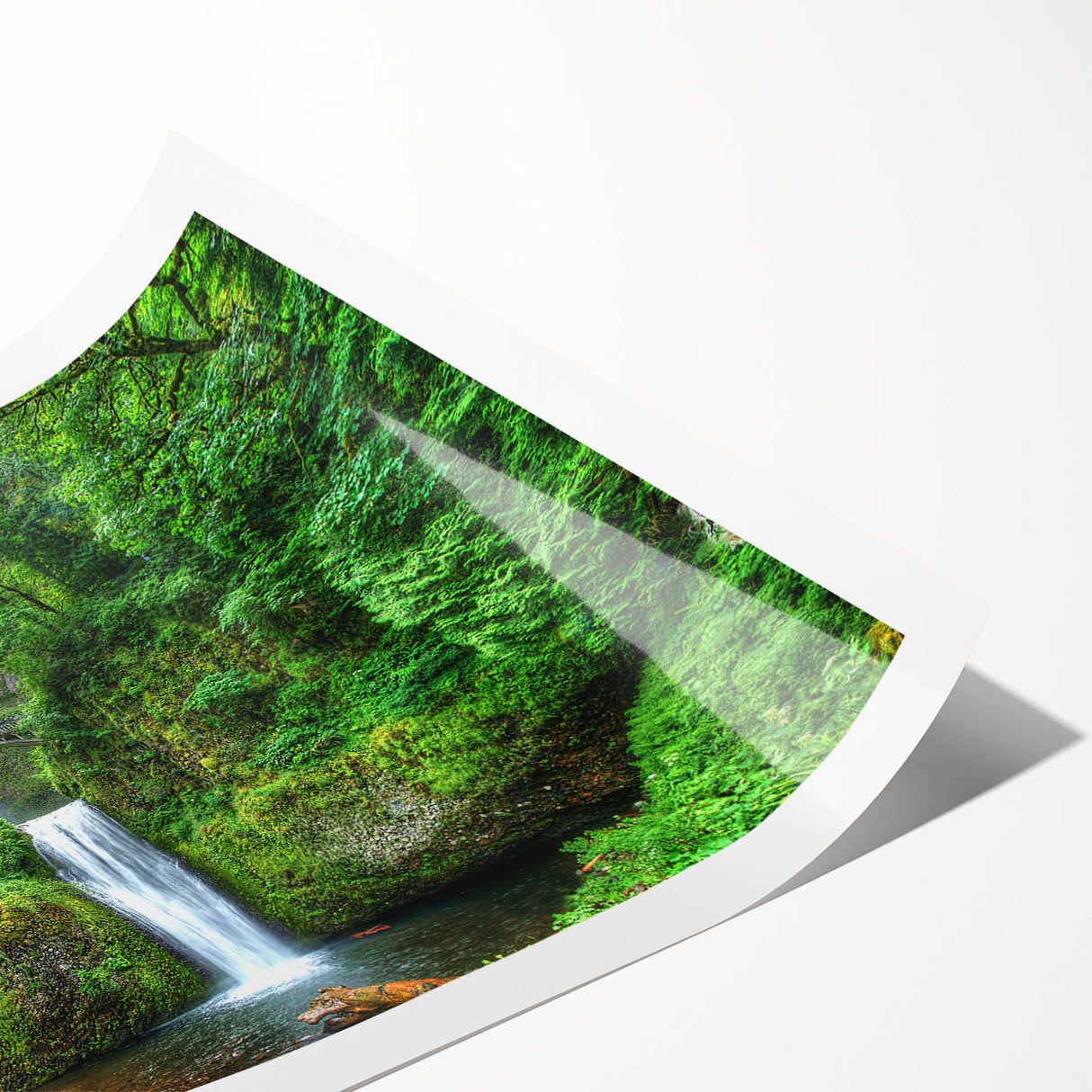 Extra large wall art of Multnomah Falls in Oregon, depicted in vibrant greens and blues on a rolled canvas.