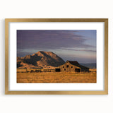 Extra large wall art featuring an abstract depiction of South Dakota scenery in textured gold and brown tones.