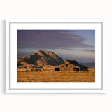 Abstract art print of South Dakota scenery in muted earth tones, framed with a white mat.