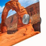 Large abstract depiction of Arches National Park in vibrant orange and red tones on acrylic glass, ideal for dining room art.