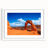 Abstract art print of Arches National Park in Utah, featuring earthy red and orange tones on a white framed canvas.
