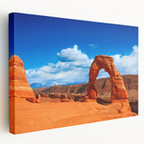 Arches National Park landscape on large stretched canvas, featuring red rock formations under a blue sky.