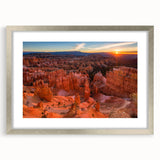 Textured art depicting abstract Bryce Canyon scenery in earth tones on a framed silver mat, suitable for bedroom decor.