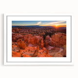 Abstract art print of Bryce Canyon in earthy red and orange tones, framed with a white mat, suitable for dining room decor.